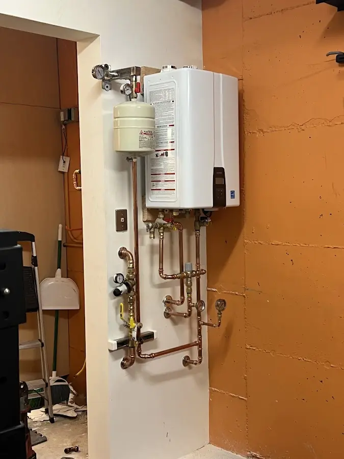 Plumbing technician inspecting water heater connections in Southeast